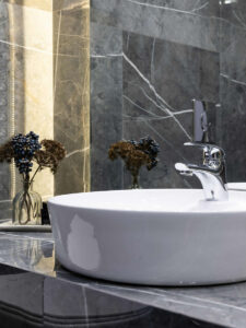 sink with dark tiles