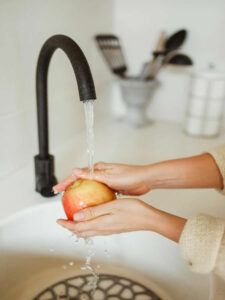 washing apple by the kitchen sink